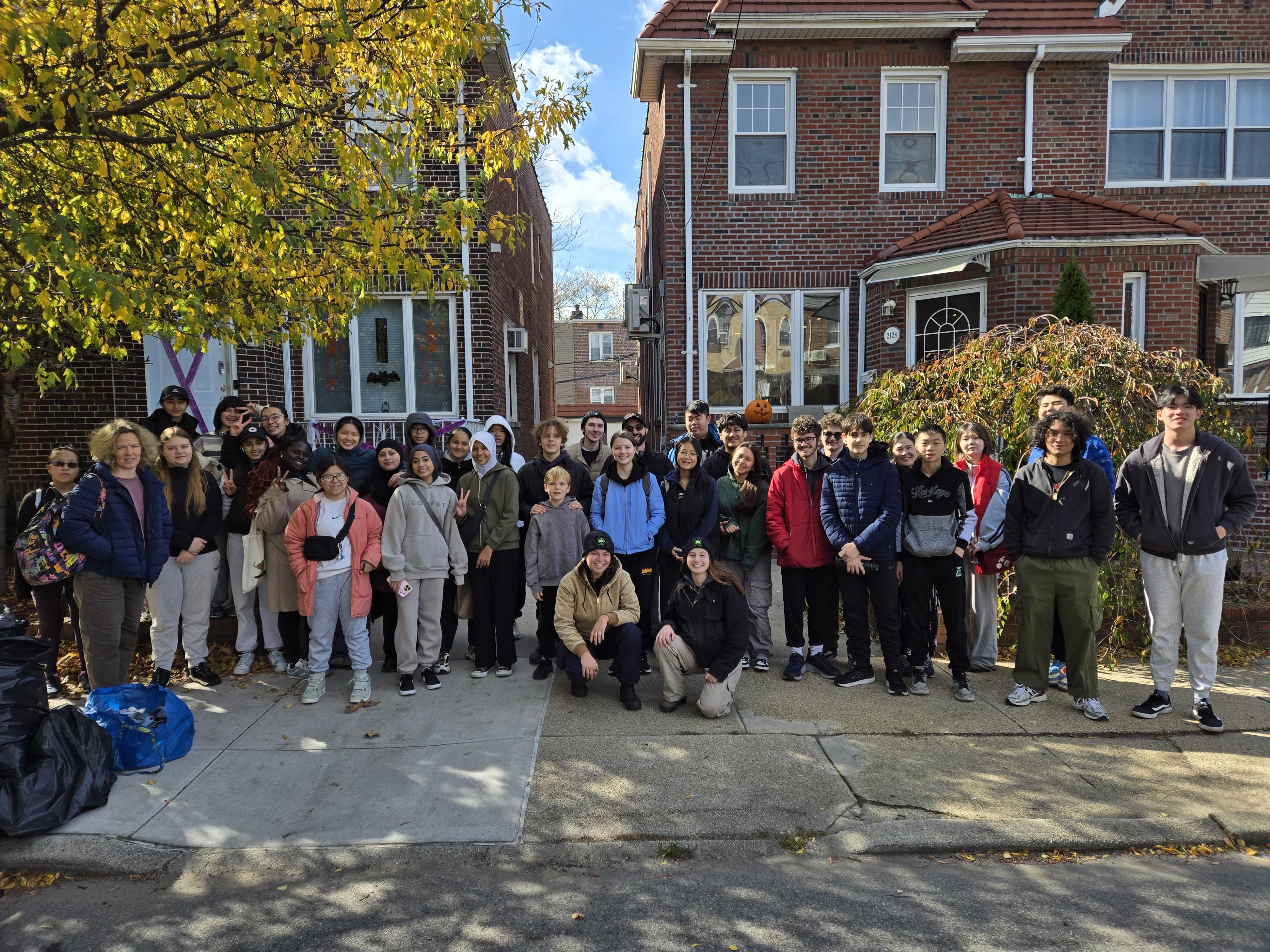 Large group of MPYAA volunteers and neighbors gathered on a Marine Park street